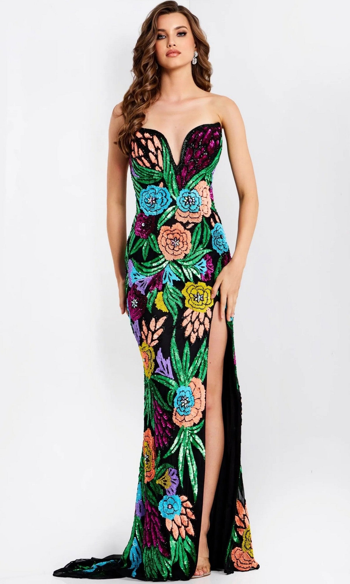 A woman wears the Jovani 49234 long prom dress, a strapless black gown with a thigh-high slit, adorned with vibrant multi-colored sequin floral and leaf patterns for a dazzling look.